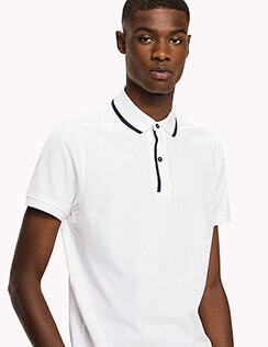 A man wearing white polo shirt with black trim.