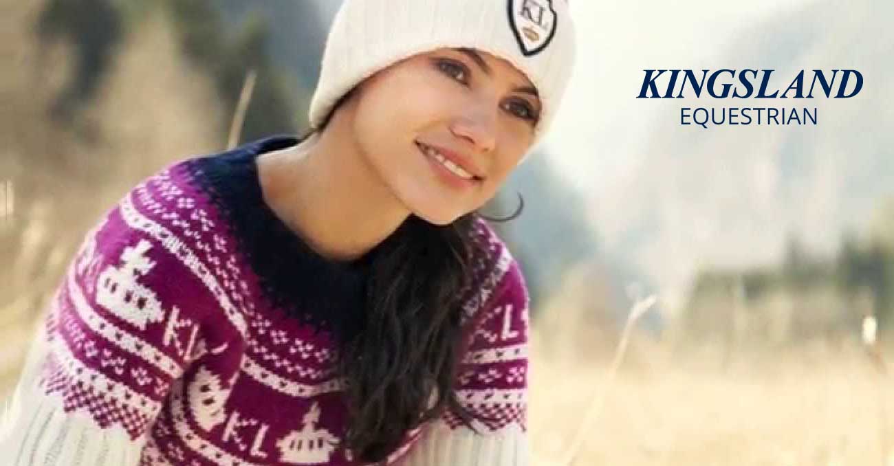 A woman wearing a knit hat and sweater.