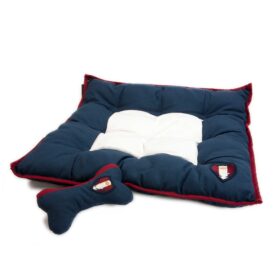 A dog bed and toy set in blue with red trim.