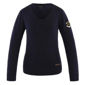 A woman wearing a black sweater with gold lettering.