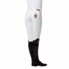 A woman wearing white pants and black boots.