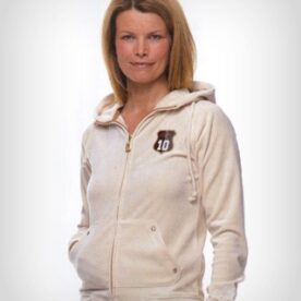 A woman wearing a white jacket with a brown and black logo.