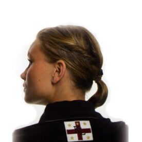 A woman with a ponytail and cross on her back.