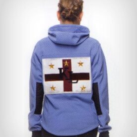 A person wearing a blue jacket with guns on it.