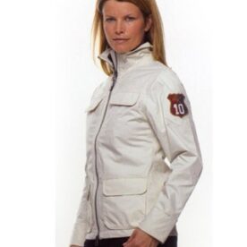 A woman wearing a white jacket with a patch on the chest.