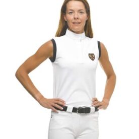 A woman in white shirt and shorts standing with hands on hips.