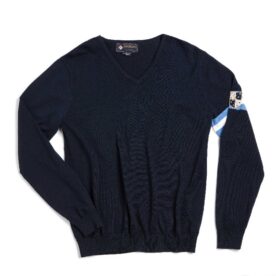 A black sweater with a blue tag on it.