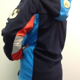 A person wearing a jacket with a patch on the back.