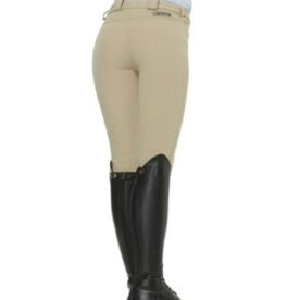 A woman wearing black boots and beige pants.