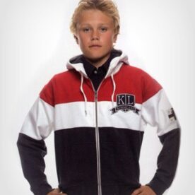 A young man wearing a red, white and black jacket.