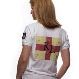 A woman wearing a white shirt with the letters kl on it.
